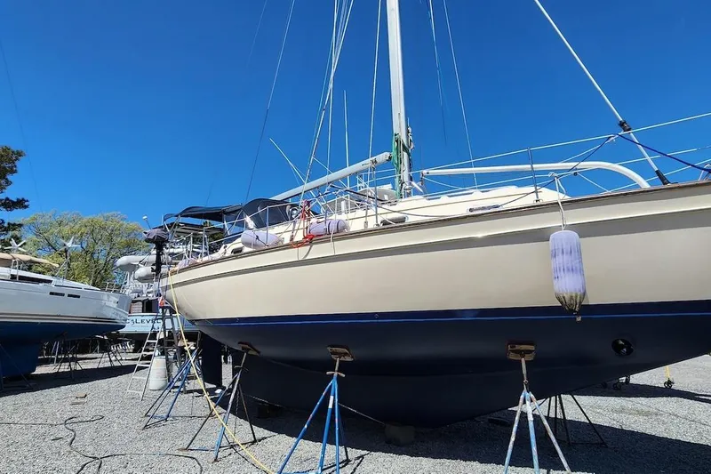Slide: The Image of 2001 Island Packet 380 sailboat on dry dock under clear blue sky. - 43