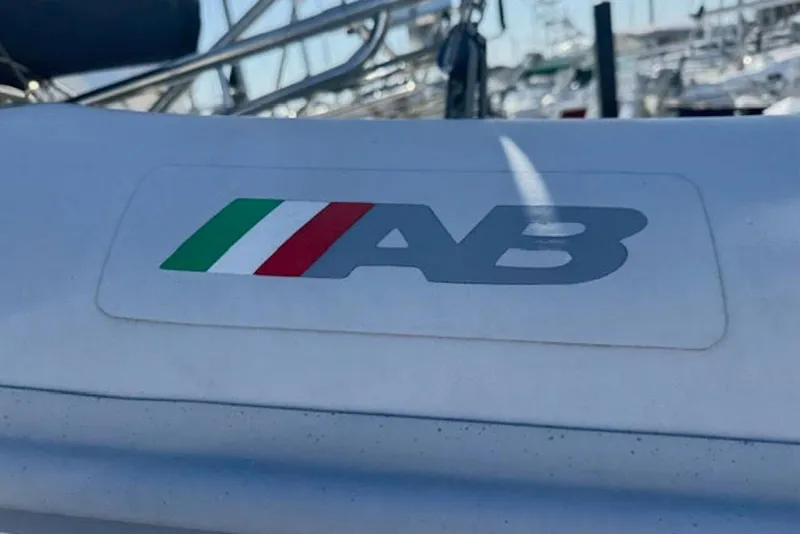 Slide: The Image of AB logo on Island Packet 380 sailboat, 2001 model, with marina background. - 45
