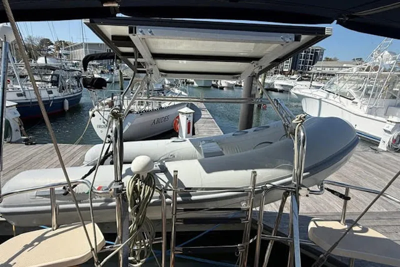 Slide: The Image of Docked Island Packet 380 sailboat from 2001 with dinghy and marina view. - 47