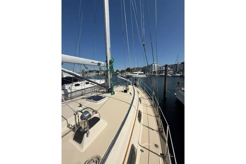 Slide: The Image of 2001 Island Packet 380 sailboat docked in a marina under clear blue skies. - 7