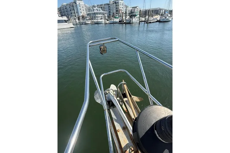 Slide: The Image of Bow of 2001 Island Packet 380 sailboat in marina, with anchor and railing visible. - 9