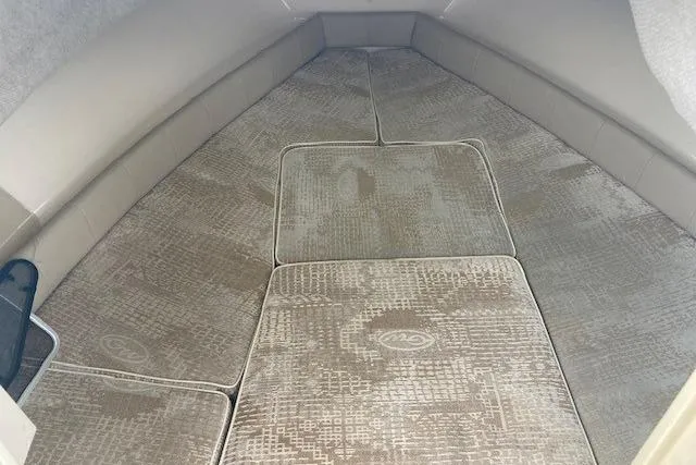 Slide: The Image of Interior cabin of a 2006 Grady White SEAFARER boat with cushioned seating. - 12