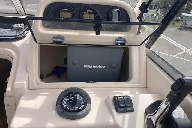 Slide: The Image of 2006 Grady White SEAFARER dashboard with Raymarine equipment and compass. - 7