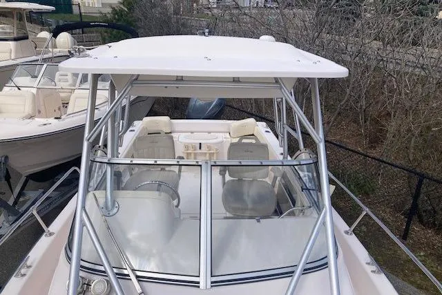 Slide: The Image of 2006 Grady White SEAFARER boat with white canopy and seating, docked outdoors. - 9