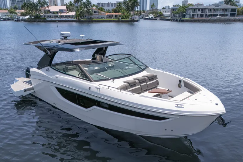 The Image of 2021 Cruisers Yachts 38 GLS boat on calm water, featuring sleek design and spacious seating. - 0