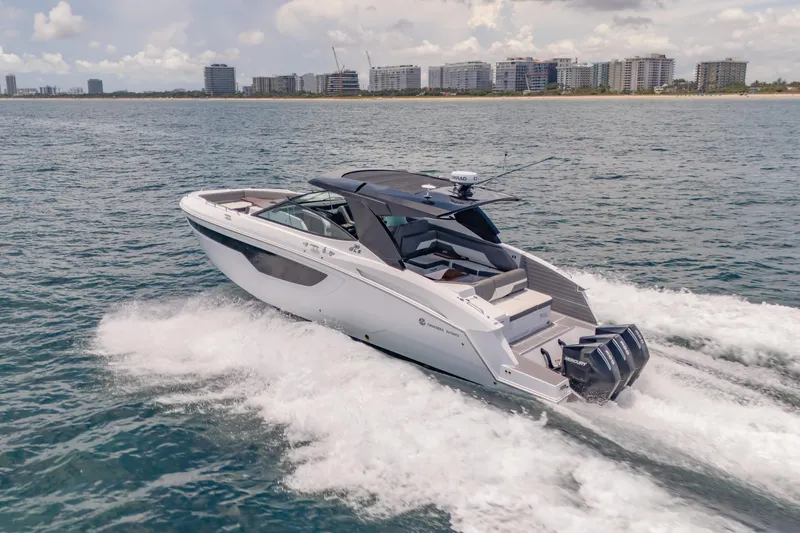 Slide: The Image of 2021 Cruisers Yachts 38 GLS speeding on ocean near city skyline. - 11