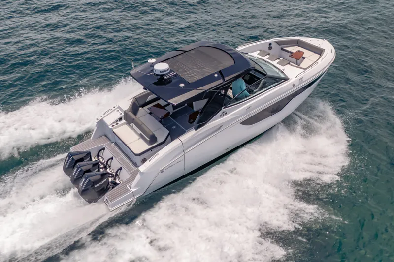 Slide: The Image of 2021 Cruisers Yachts 38 GLS speeding on open water, showcasing sleek design and powerful engines. - 13