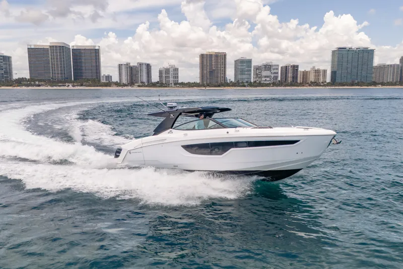 Slide: The Image of 2021 Cruisers Yachts 38 GLS cruising near city skyline on a sunny day. - 16