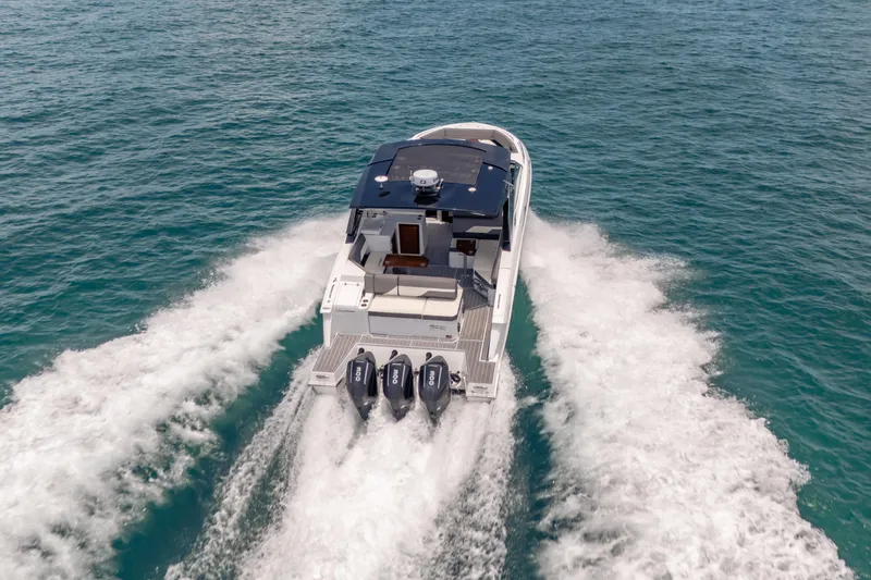 Slide: The Image of 2021 Cruisers Yachts 38 GLS speeding on open water, showcasing powerful triple engines. - 18