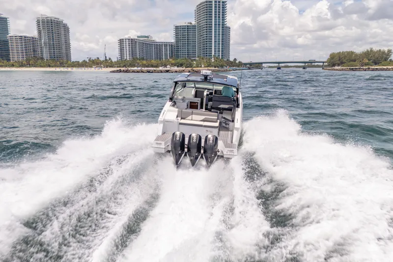 Slide: The Image of 2021 Cruisers Yachts 38 GLS speeding on water near city skyline. - 19