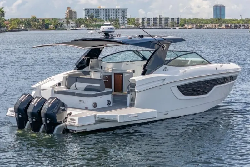 Slide: The Image of 2021 Cruisers Yachts 38 GLS on water, featuring triple outboard engines and sleek design. - 2