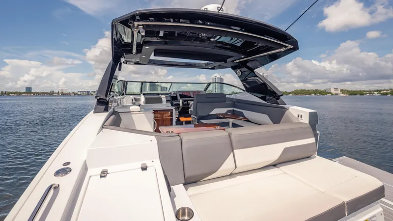 Slide: The Image of 2021 Cruisers Yachts 38 GLS luxury boat with spacious seating on a sunny day. - 21