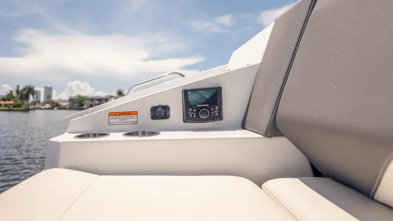 Slide: The Image of 2021 Cruisers Yachts 38 GLS interior with control panel and cup holders, overlooking water. - 22