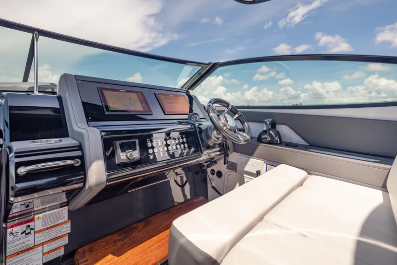 Slide: The Image of 2021 Cruisers Yachts 38 GLS helm with modern controls and navigation screens. - 33