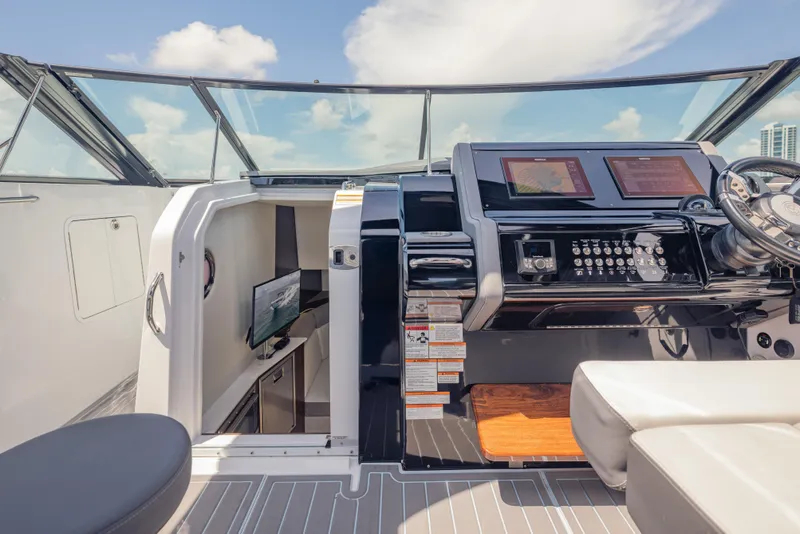 Slide: The Image of 2021 Cruisers Yachts 38 GLS helm with modern controls and cabin view. - 35