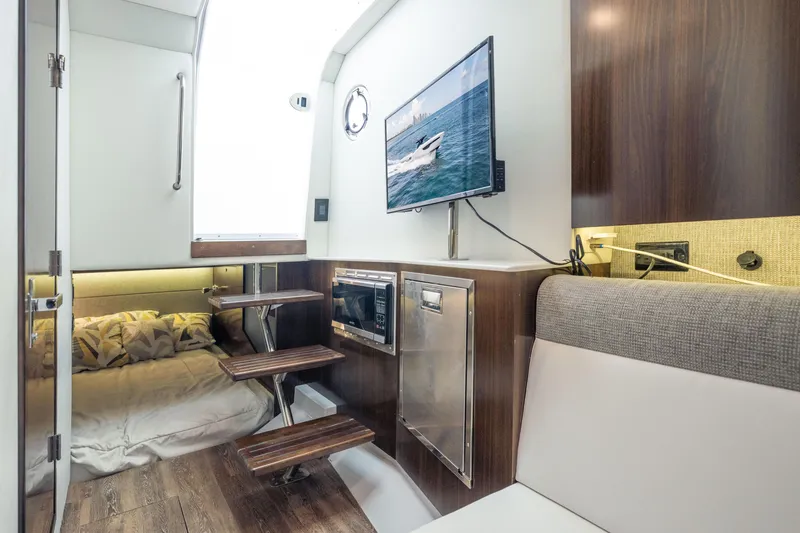 Slide: The Image of Interior of 2021 Cruisers Yachts 38 GLS with cozy bed, TV, and modern amenities. - 36