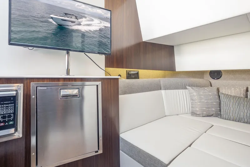 Slide: The Image of Interior of 2021 Cruisers Yachts 38 GLS with TV and modern seating area. - 38