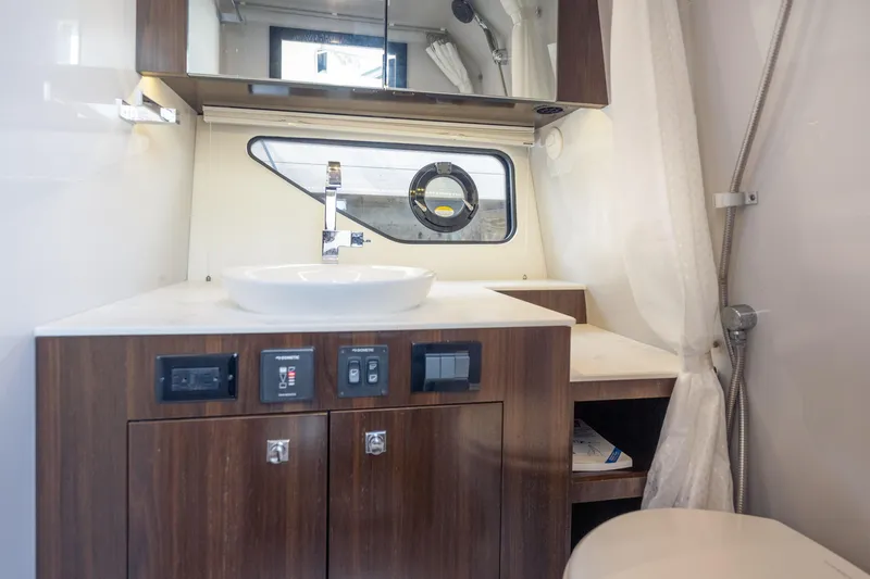 Slide: The Image of 2021 Cruisers Yachts 38 GLS bathroom with modern sink and wood cabinetry. - 41