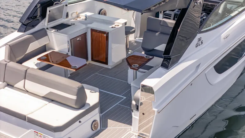 Slide: The Image of 2021 Cruisers Yachts 38 GLS luxury boat interior with seating and kitchenette. - 6