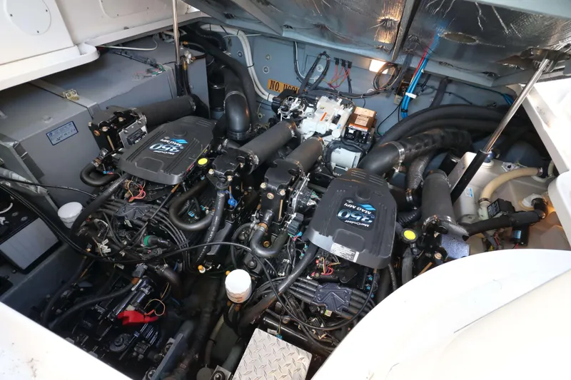 Slide: The Image of Engine room of a 2004 Sea Ray Sundancer 320, showcasing dual MerCruiser engines. - 14