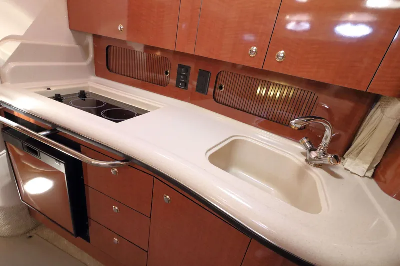 Slide: The Image of Luxurious 2004 Sea Ray Sundancer 320 yacht kitchen with sleek cabinetry and modern appliances. - 18