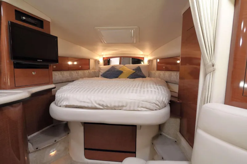 Slide: The Image of Luxurious cabin interior of 2004 Sea Ray Sundancer 320 yacht with cozy bed and TV. - 19
