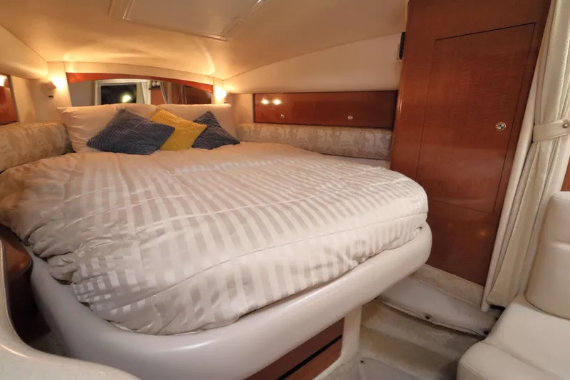 Slide: The Image of Luxurious cabin interior of 2004 Sea Ray Sundancer 320 with cozy bed and ambient lighting. - 20