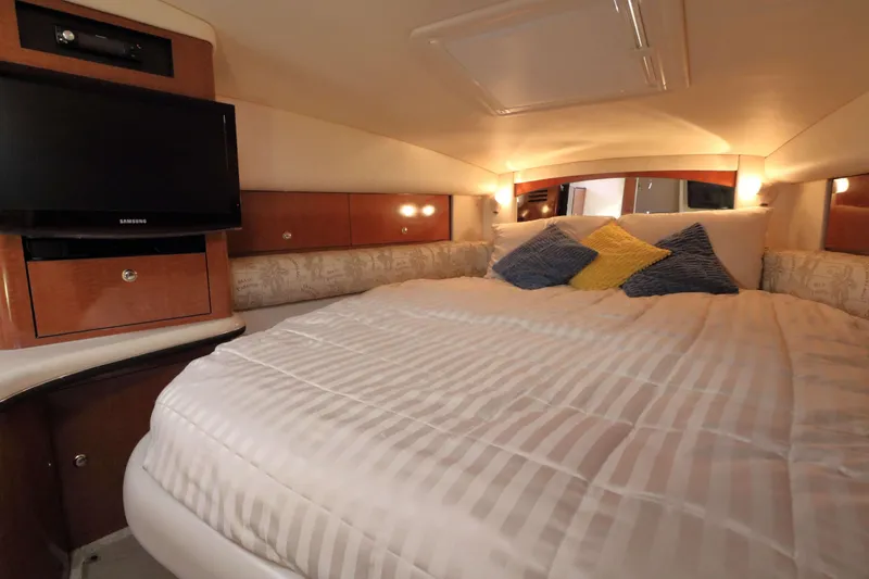 Slide: The Image of Luxurious cabin interior of 2004 Sea Ray Sundancer 320 with cozy bedding and TV. - 21