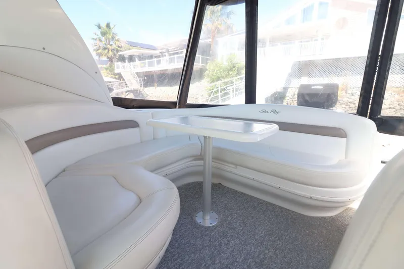 Slide: The Image of Interior of 2004 Sea Ray Sundancer 320 with white seating and table. - 3