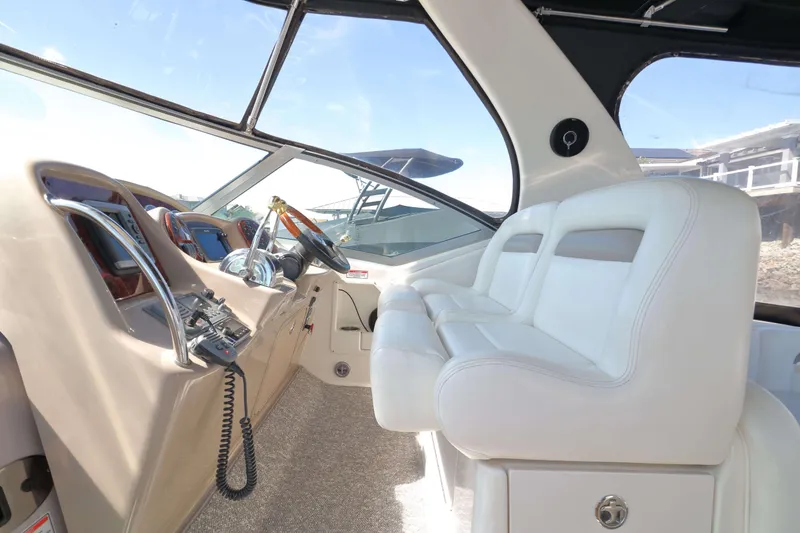 Slide: The Image of Interior cockpit of 2004 Sea Ray Sundancer 320 with white seating and control panel. - 5
