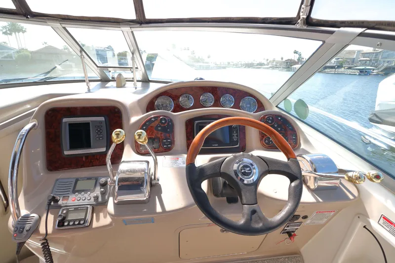 Slide: The Image of Helm of 2004 Sea Ray Sundancer 320 with steering wheel and navigation controls. - 7