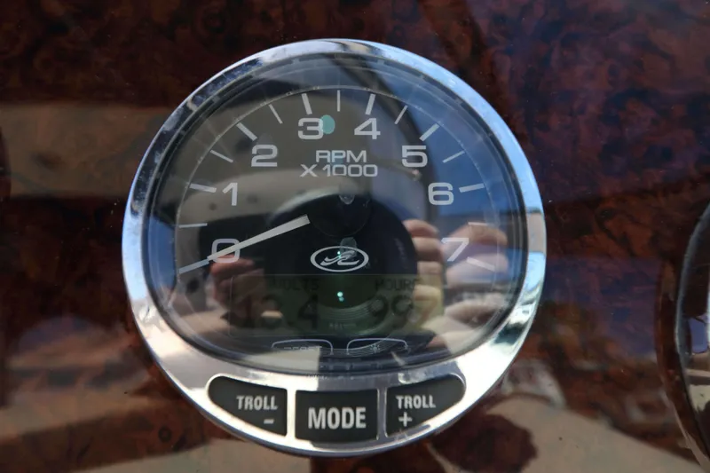 Slide: The Image of Close-up of a 2004 Sea Ray Sundancer 320 tachometer displaying RPM and controls. - 9