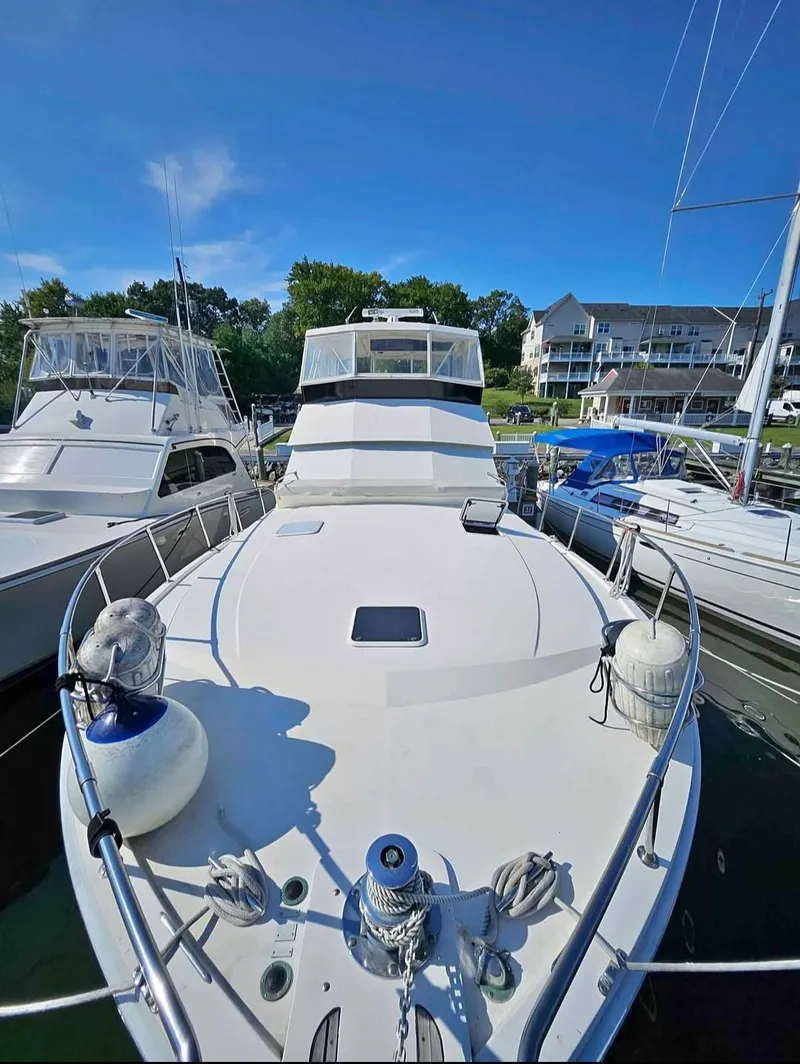 Slide: The Image of 2003 Carver 444 Cockpit Motor Yacht docked at marina. - 39