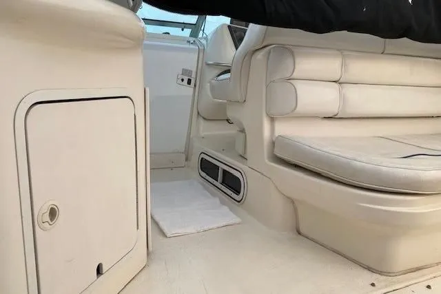 Slide: The Image of Interior of a 1996 Sea Ray Sundancer 330 boat, featuring white leather seating. - 22