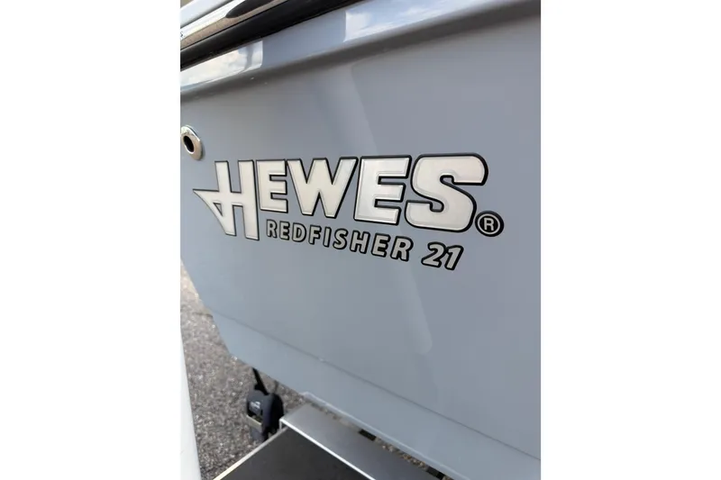 Slide: The Image of 2023 Hewes Redfisher 21 boat logo on sleek gray hull. - 14