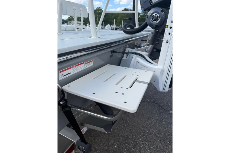 Slide: The Image of 2023 Hewes Redfisher 21 boat with a foldable swim platform and steering console. - 7