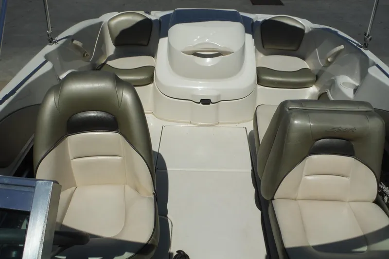 Slide: The Image of Interior of a 2004 Sea Ray 180 Sport boat with beige seating. - 10