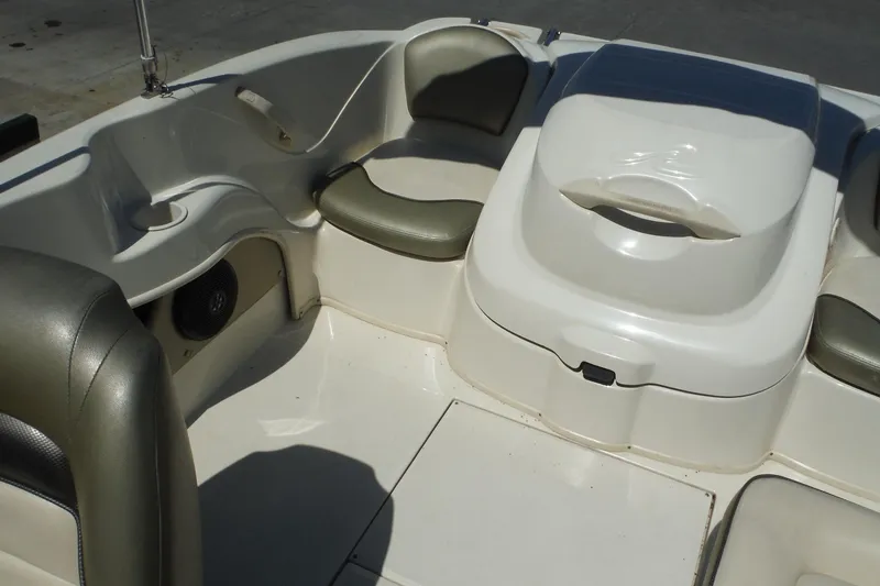 Slide: The Image of 2004 Sea Ray 180 Sport boat interior with seating and storage compartments. - 11