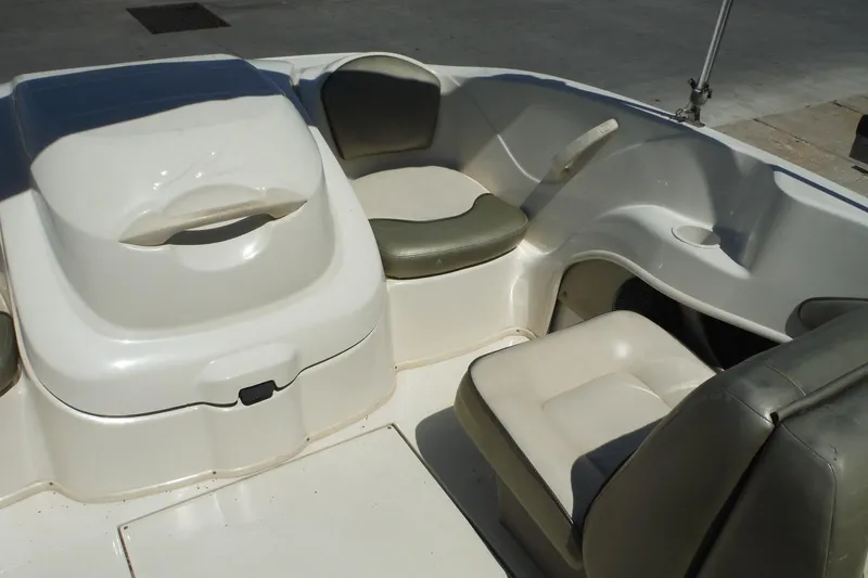 Slide: The Image of Interior seating of a 2004 Sea Ray 180 Sport boat, featuring cushioned seats. - 12