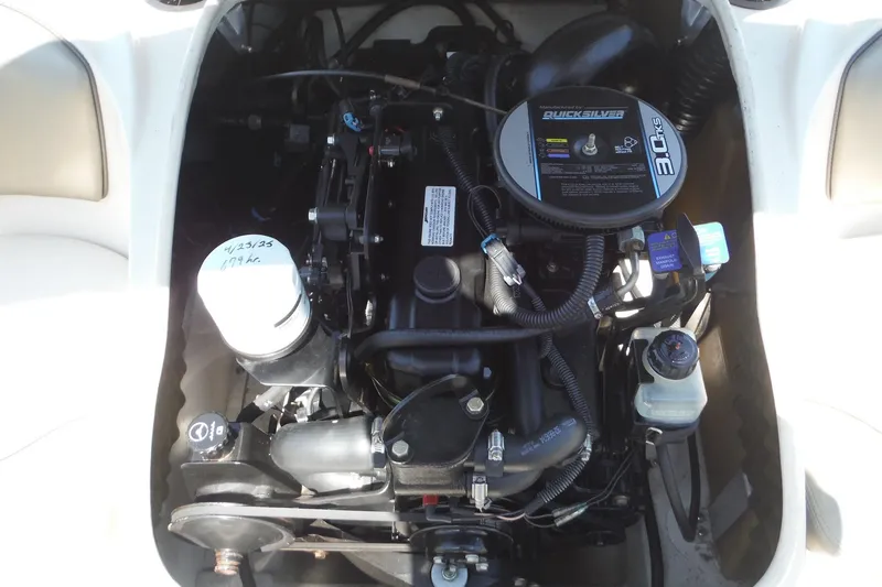 Slide: The Image of Engine compartment of a 2004 Sea Ray 180 Sport boat, showcasing the Quicksilver 3.0L engine. - 13