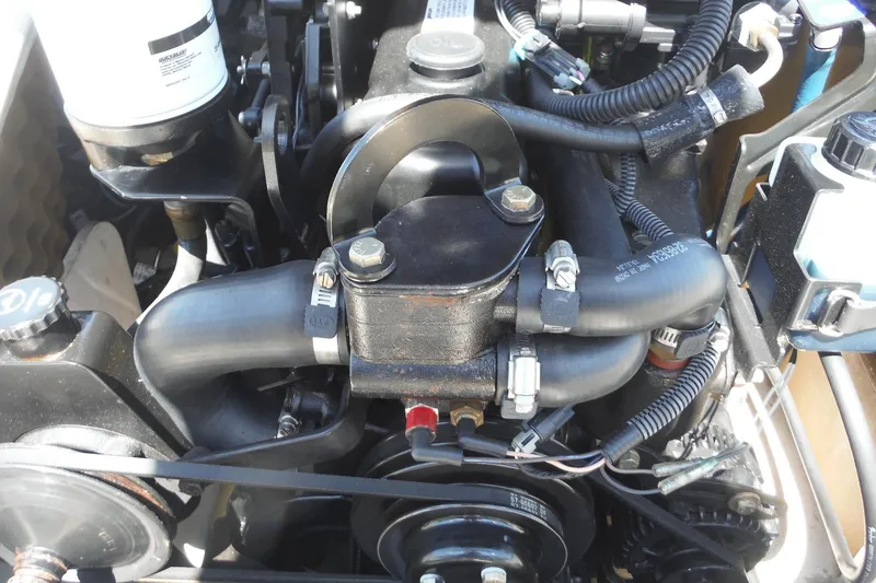 Slide: The Image of Engine components of a 2004 Sea Ray 180 Sport boat, featuring hoses and wiring. - 15