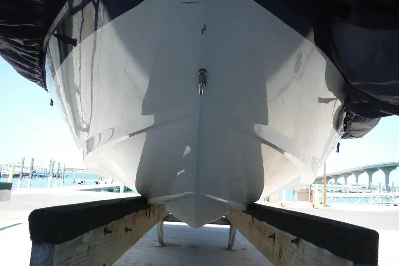 Slide: The Image of 2004 Sea Ray 180 Sport boat on a dock, viewed from below, with a bridge in the background. - 22
