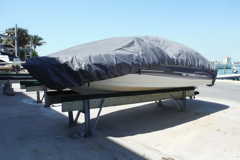Slide: The Image of Covered 2004 Sea Ray 180 Sport boat on a dock, sunny day, marina background. - 23