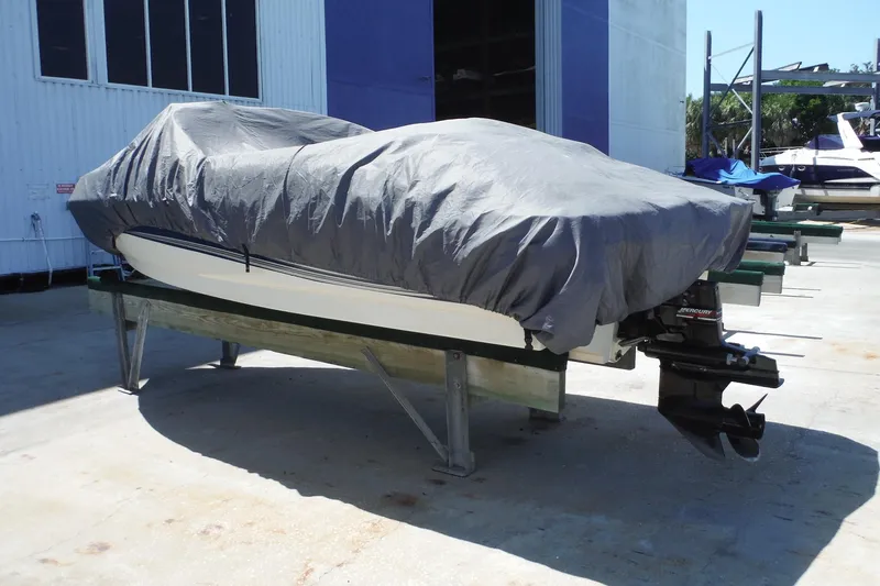 Slide: The Image of Covered 2004 Sea Ray 180 Sport boat on a stand outside a storage facility. - 4