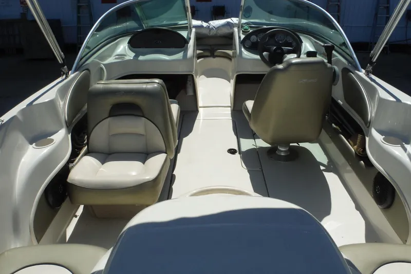 Slide: The Image of Interior of a 2004 Sea Ray 180 Sport boat, featuring seating and steering wheel. - 6
