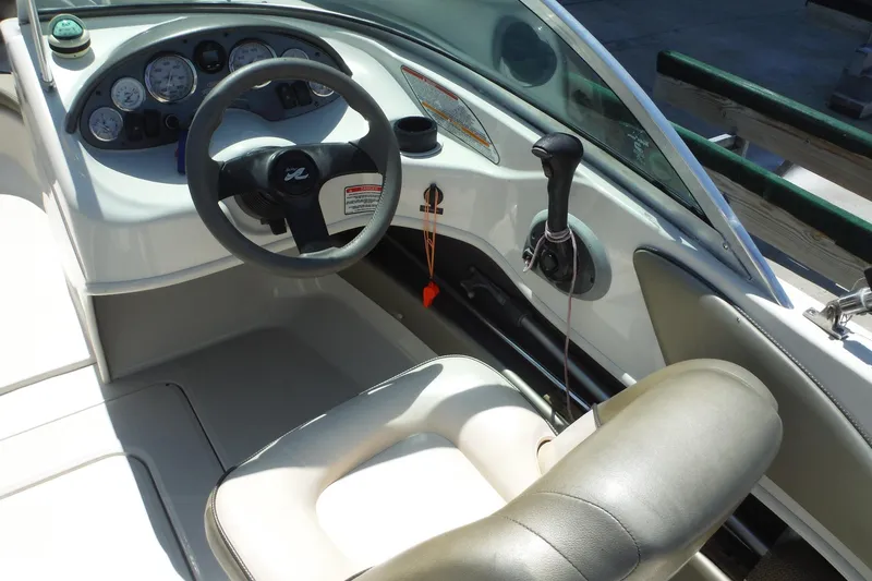 Slide: The Image of 2004 Sea Ray 180 Sport boat cockpit with steering wheel and control panel. - 7