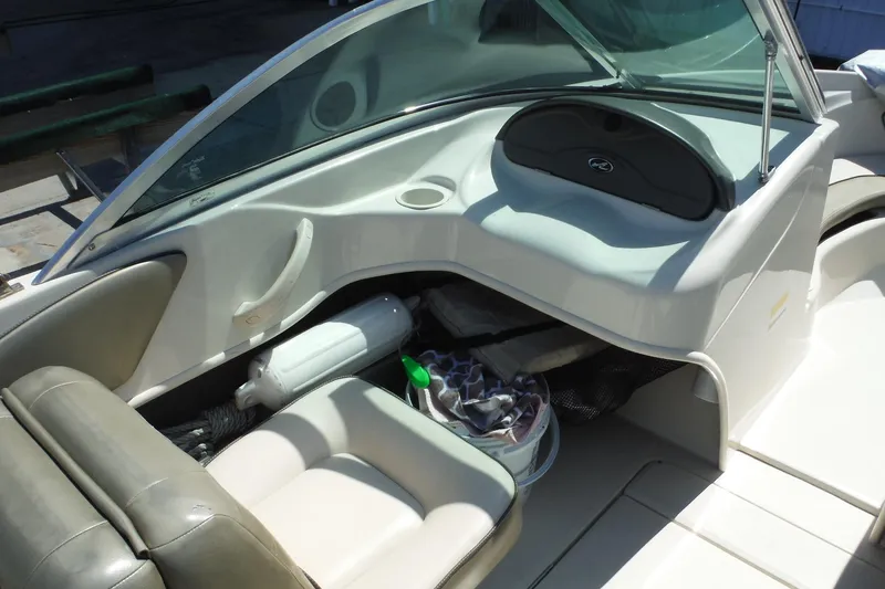 Slide: The Image of 2004 Sea Ray 180 Sport boat interior with seating and storage compartments. - 8