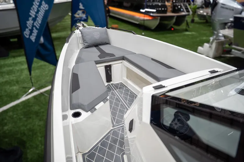 Slide: The Image of 2026 Iron 907 Coupe boat interior with gray seating and modern design. - 13