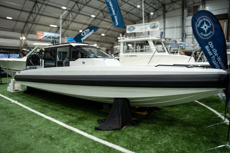 Slide: The Image of 2026 Iron 907 Coupe boat displayed indoors at a marine exhibition. - 4