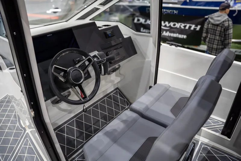 Slide: The Image of Interior of 2026 Iron 907 Coupe boat with modern steering and seating. - 8